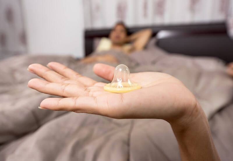 Kondom na dłoni kobiety, prezerwatywa
